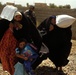 Iraqi Soldiers Hand Out Food After Clearing Operation