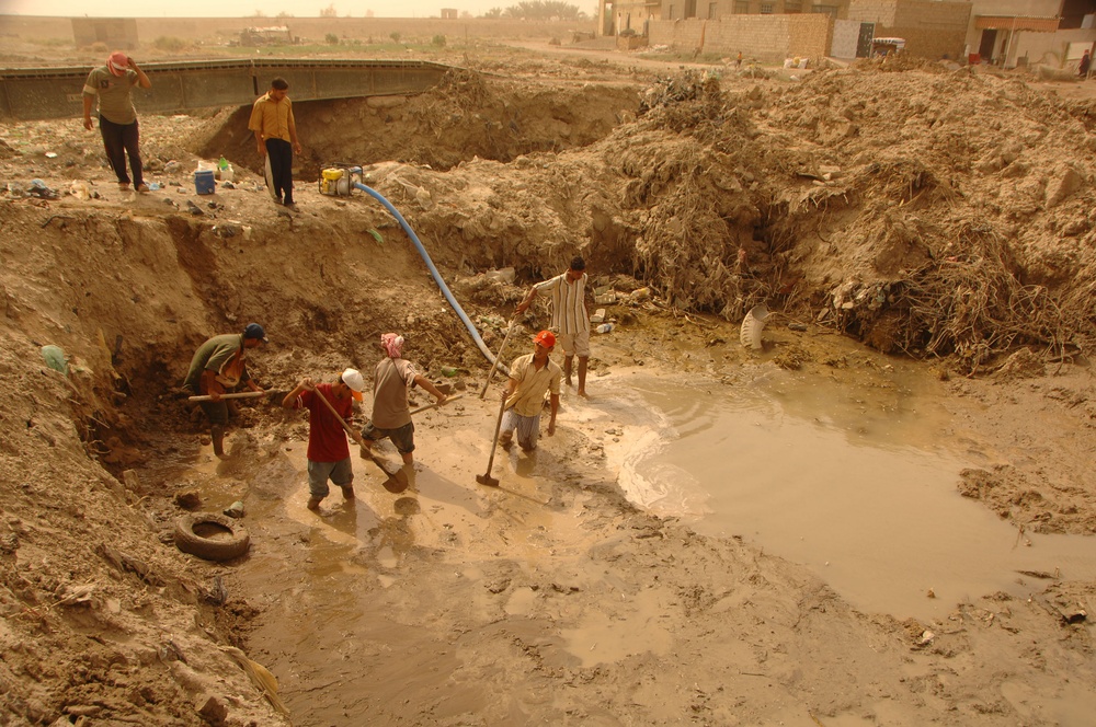 Soldiers and Marines deliver generator to a clinic and help build new road