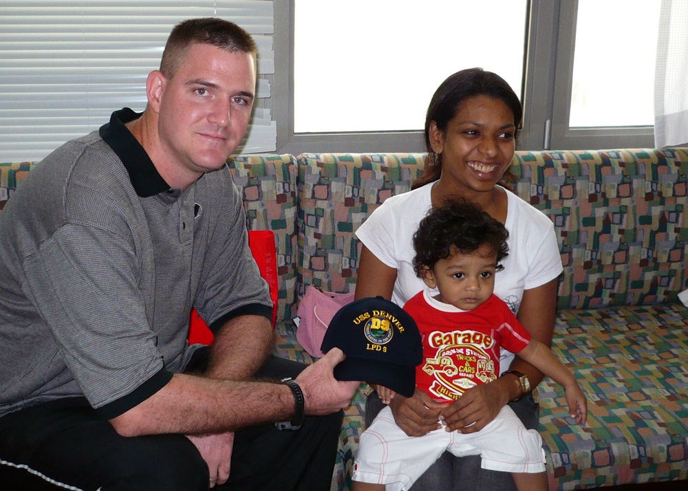 Donaher presents a &quot;D9&quot; command ball cap to a young patient and her mother