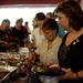 Family, friends, and soldiers enjoy a grilled meal