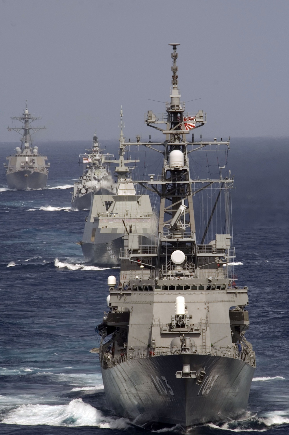 JS Yuudachi leads a formation of ships