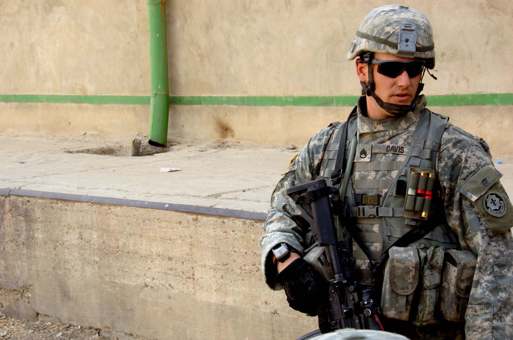 Soldiers Patrol throught the streets of Baghdad