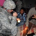 Cavalry Soldiers provide aid to injured Iraqi man injured during insurgent