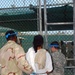 U.S. Army and Navy Guard escort a detainee to recreational area