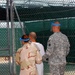 U.S. Army and Navy Guard escort a detainee to recreational area