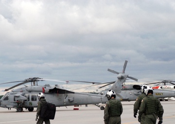 Helicopter flight students find their assigned helicopters
