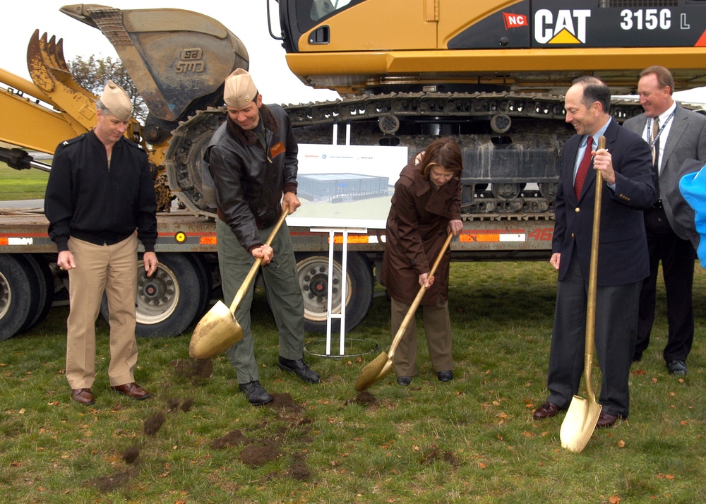 Leaders use gold shovels to dig holes for ceremony