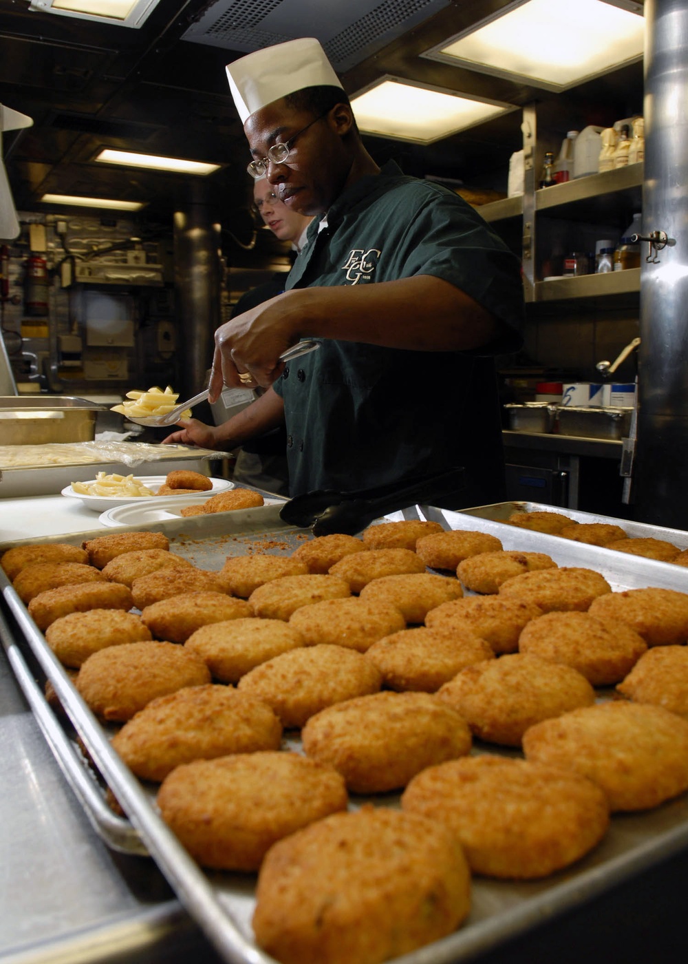 Seaman prepares crab cakes