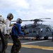 Flight deck firefighters attack a simulated fire on USS Tarawa