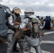 Flight deck firefighters attack a simulated fire on USS Tarawa