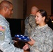 Spc. Lina Jergees, a linguist with the 177th Military Police Brigade, receives a U.S. flag from the 316th Expeditionary Sustainment Command senior enlisted leader, Command Sgt. Maj. Stacey E. Davis, Nov. 11, at Logistic Support Area. Along with 177 other