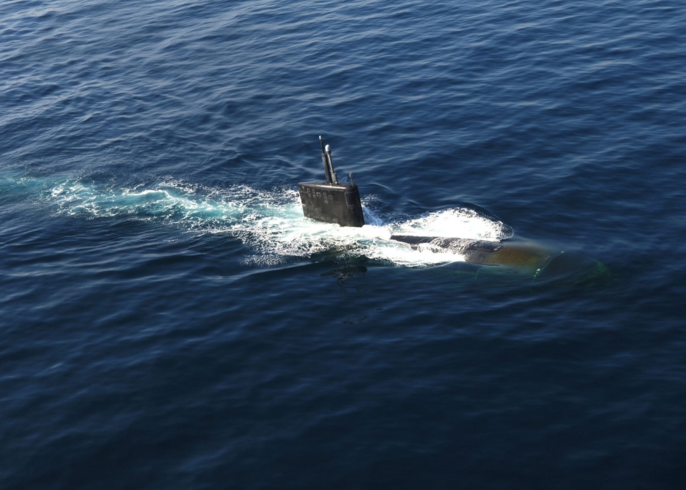 USS Miami submarine surfaces for exercise