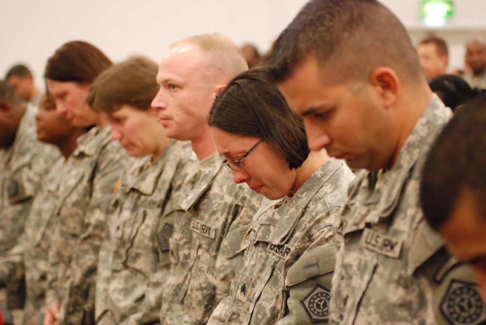 Grieving Soldiers at memorial service for fallen comrade