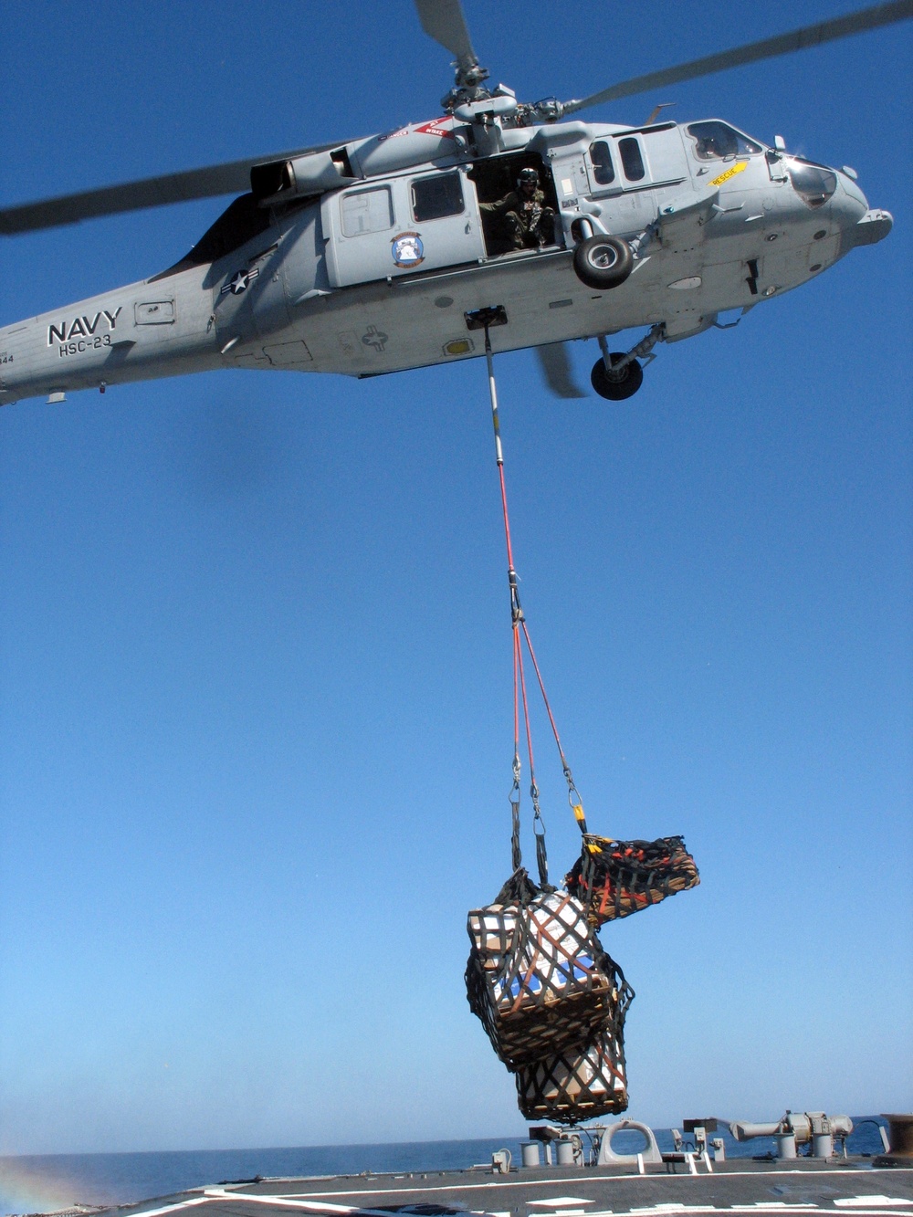 MH-60S Seahawk unloads pallets of food and mail