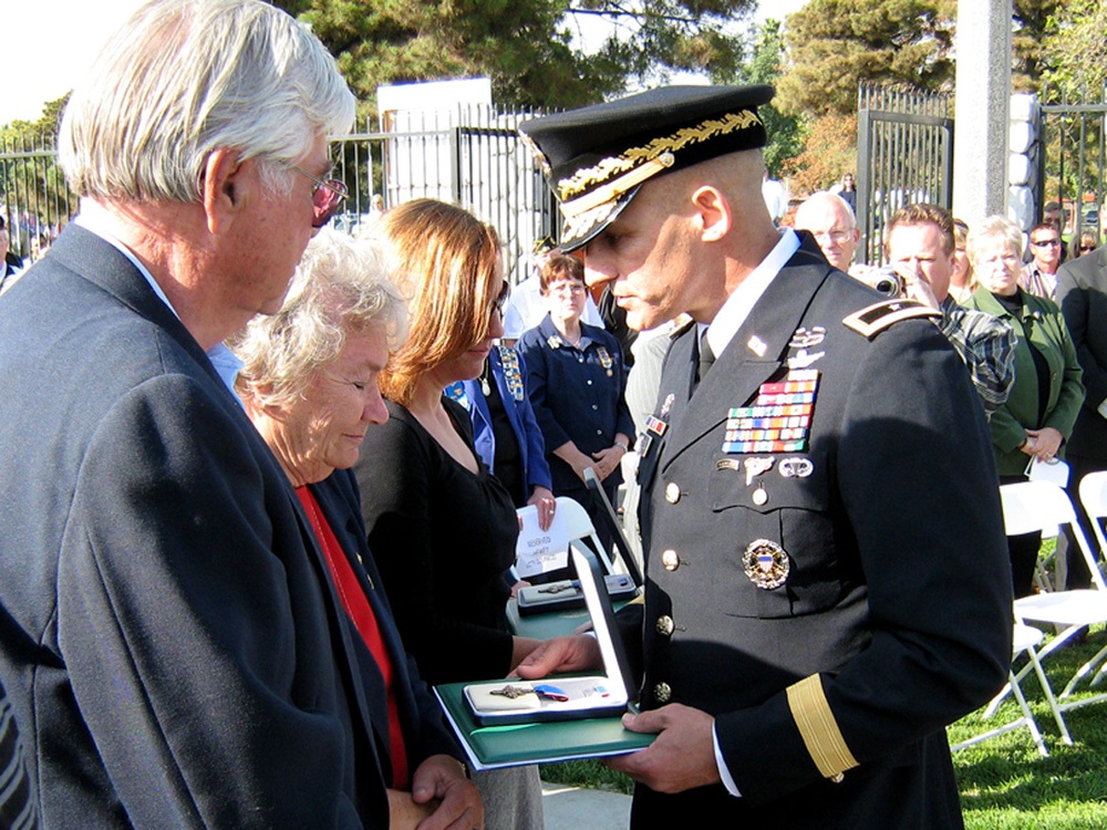 During a ceremony, Nov. 11, at the Hemet, Calif., Veteran's Memorial, Brig. Gen. Ricky Rife, right, director of program analysis and evaluation, office of the Deputy Chief of Staff, presents the Distinguished Service Cross to Phoebe, second from left, and