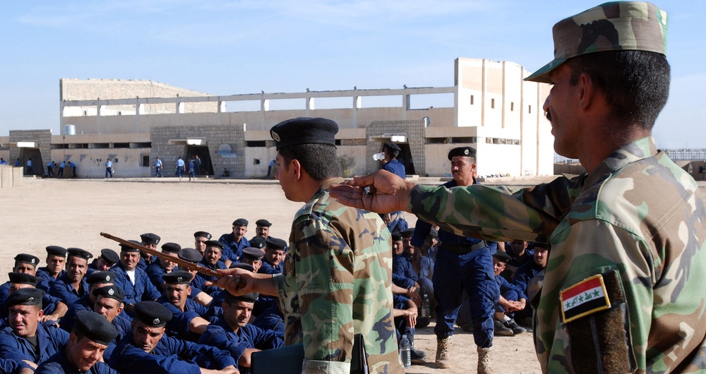 Iraqi police instructors demonstrate arrest procedures
