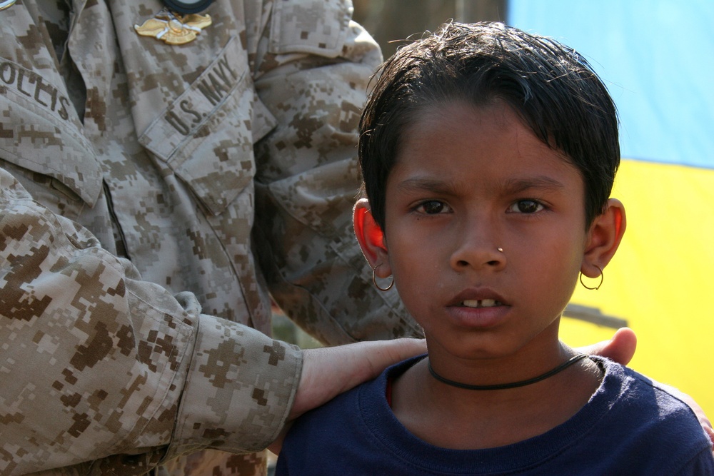 Navy corpsmen render medical aid to victims of Tropical Cyclone Sidr