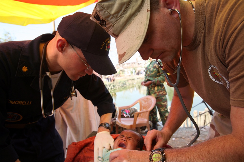 Navy corpsmen render medical aid to victims of Tropical Cyclone Sidr