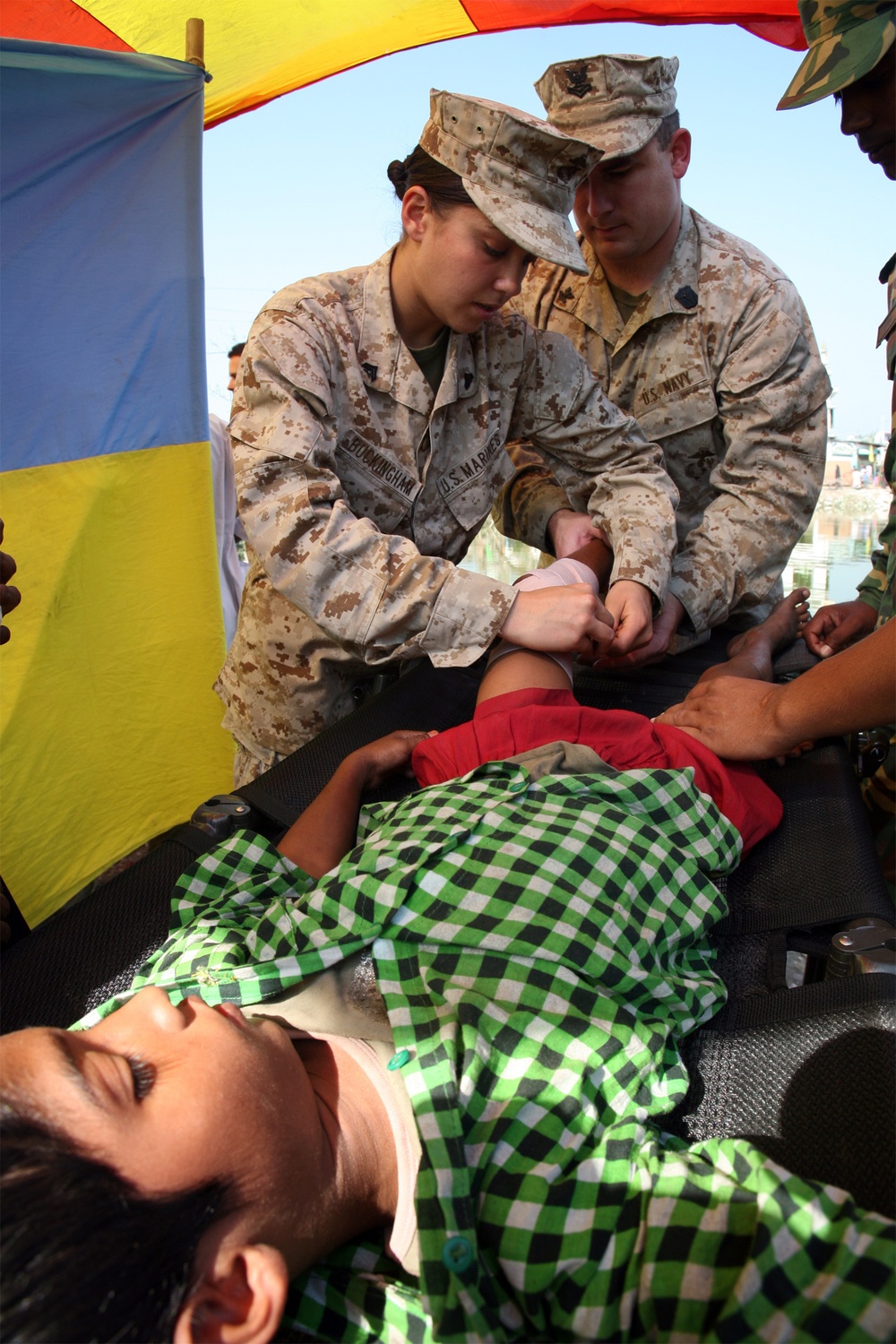 Navy corpsmen render medical aid to victims of Tropical Cyclone Sidr