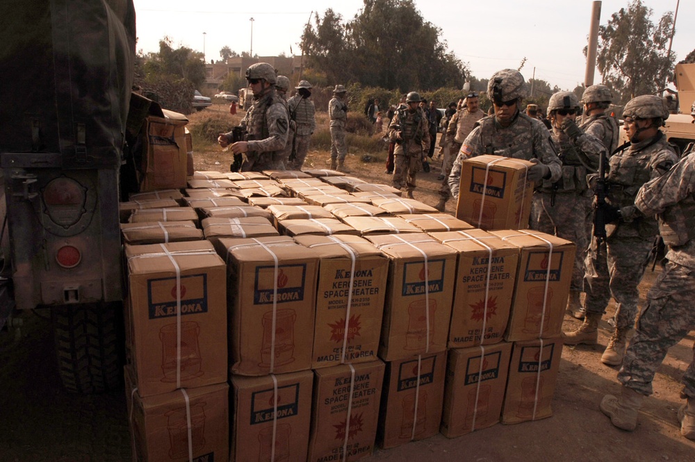 With colder weather on the way, troops distribute heaters in central Baghda