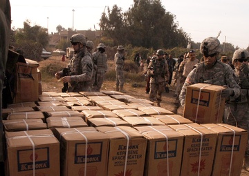 With colder weather on the way, troops distribute heaters in central Baghda