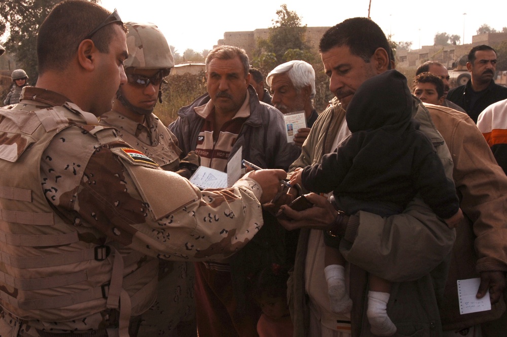 With colder weather on the way, troops distribute heaters in central Baghda