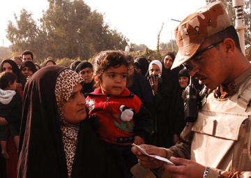 With colder weather on the way, troops distribute heaters in central Baghda