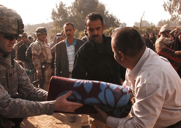 With colder weather on the way, troops distribute heaters in central Baghda