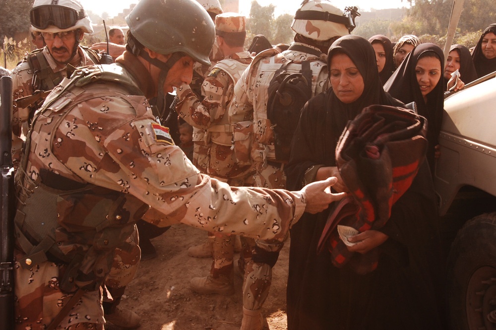 With colder weather on the way, troops distribute heaters in central Baghda