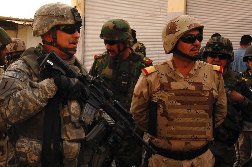 U.S. Army and Iraqi soldiers patrol side by side