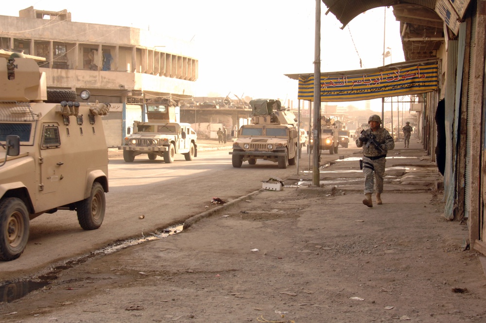 U.S. Army and Iraqi soldiers patrol side by side