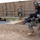 Sappers clear dangerous route essential to Operation Raider Harvest Three U.S. Army soldiers in full combat gear are conducting what appears to be a security patrol or inspection of a water control structure or canal lock facility. The soldiers are wearing ACU (Army Combat Uniform) pattern camouflage and are armed with M4 carbines. A unit patch consistent with the 2nd Infantry Division is visible on the foreground soldier's left shoulder.