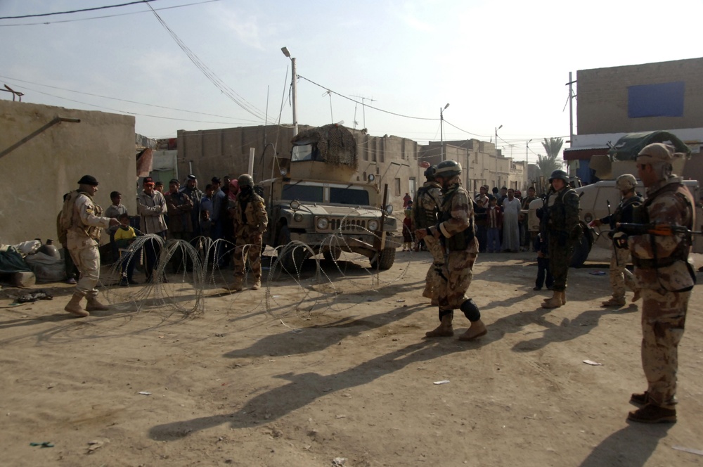 Soldiers distribute care packages to Iraqi civilians