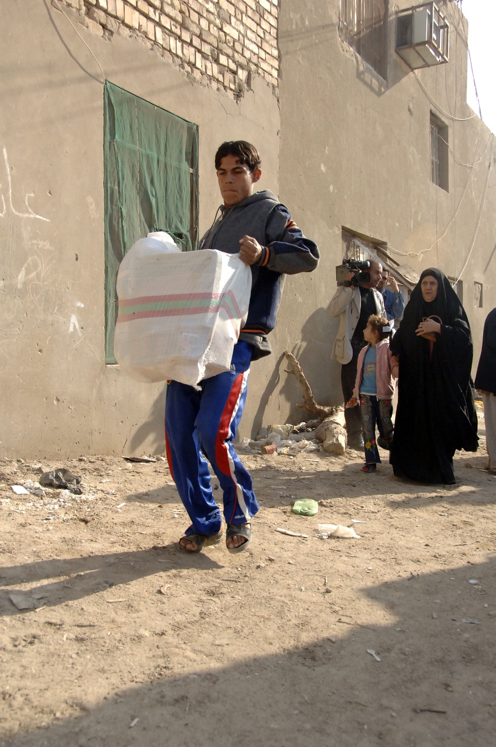 Soldiers distribute care packages to Iraqi civilians