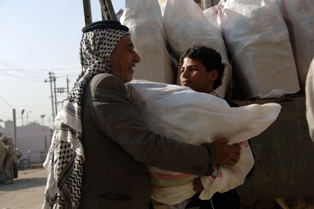 Soldiers distribute care packages to Iraqi civilians