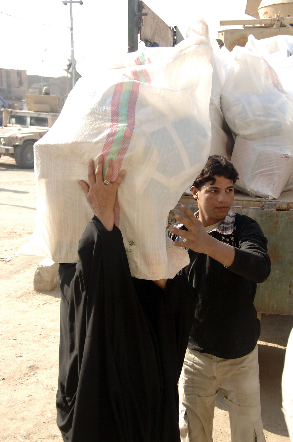 Soldiers distribute care packages to Iraqi civilians