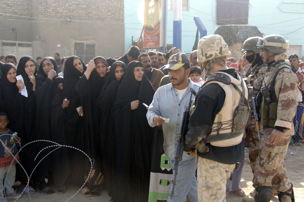 Soldiers distribute care packages to Iraqi civilians