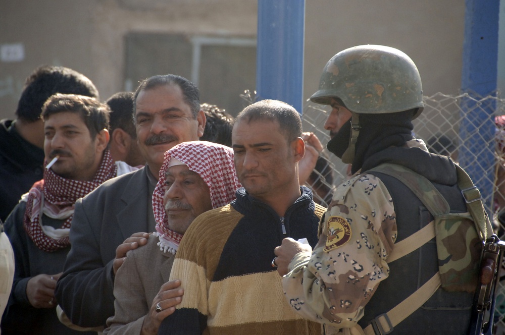 Soldiers distribute care packages to Iraqi civilians