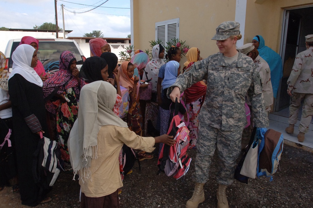 CJTF-HOA volunteers donate book bags with supplies to orphans