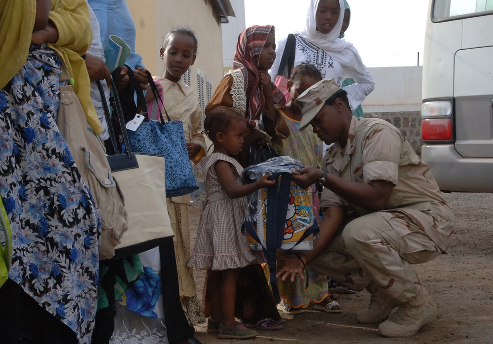CJTF-HOA volunteers donate book bags with supplies to orphans