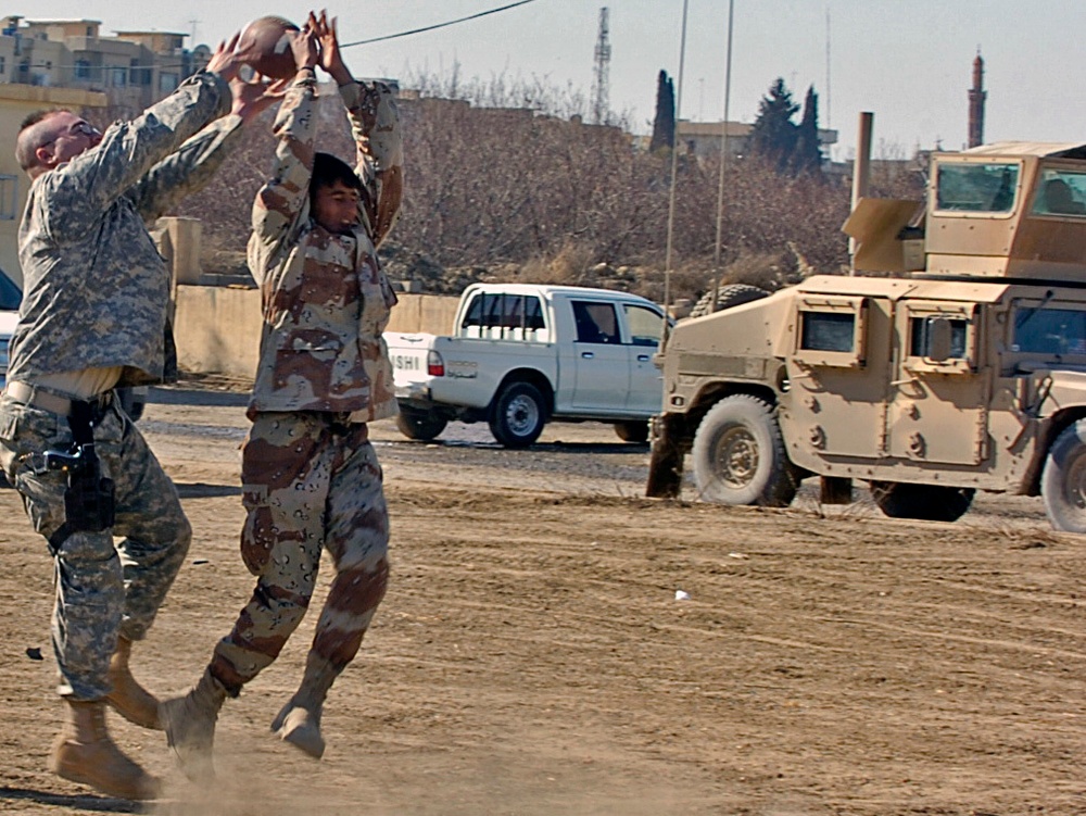 Iraqis, CF Soldiers work and play together