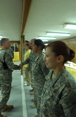 Maj. Gen. Robert Pollmann talks with service members