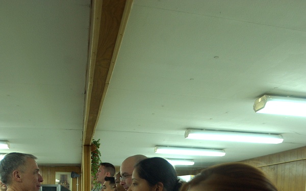 Maj. Gen. Robert Pollmann talks with service members