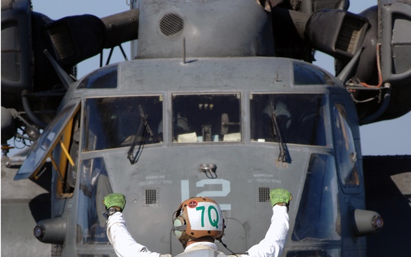 A Sailor Signals a Pilot