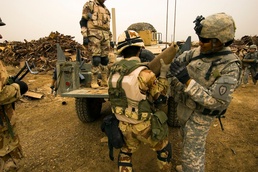 Multi-National Division - Baghdad Troops sweep junkyard for potential munitions