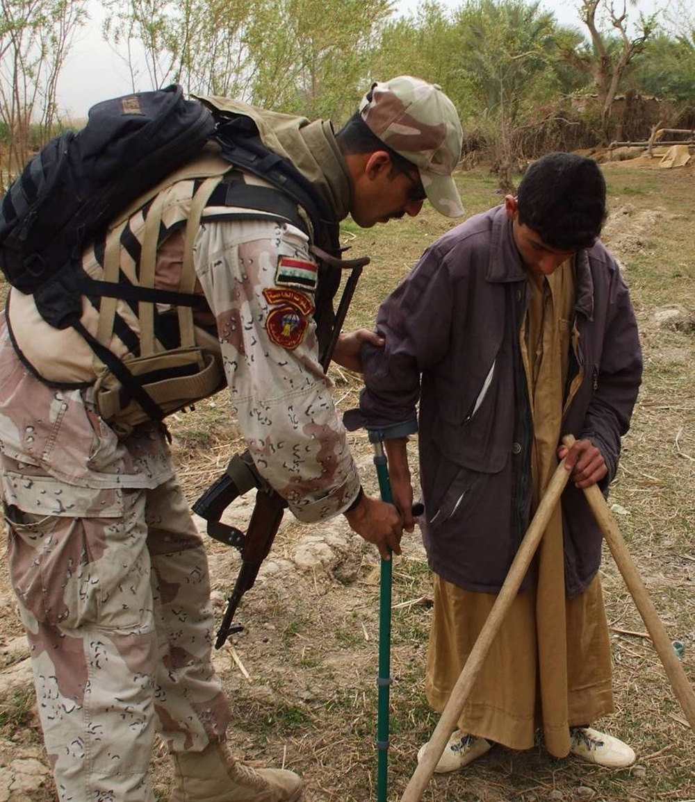 Disabled boy receives crutches from Soldiers