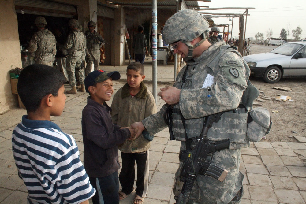 Soldiers shop, greet people at the market