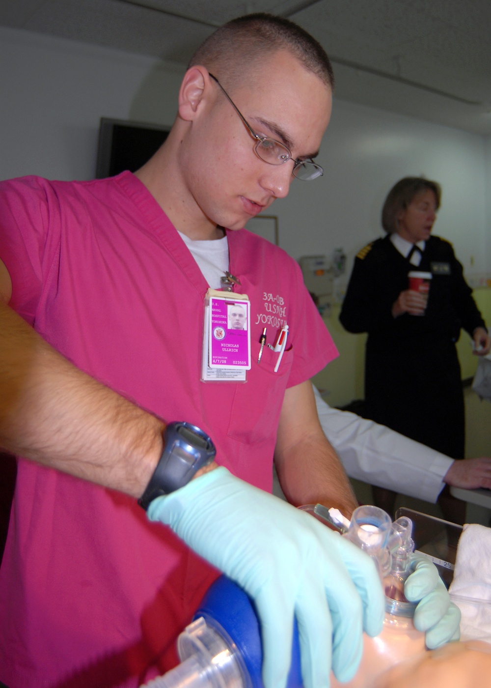 Petty Officer Nicholas Ullrich Practices with Baby Mannequin