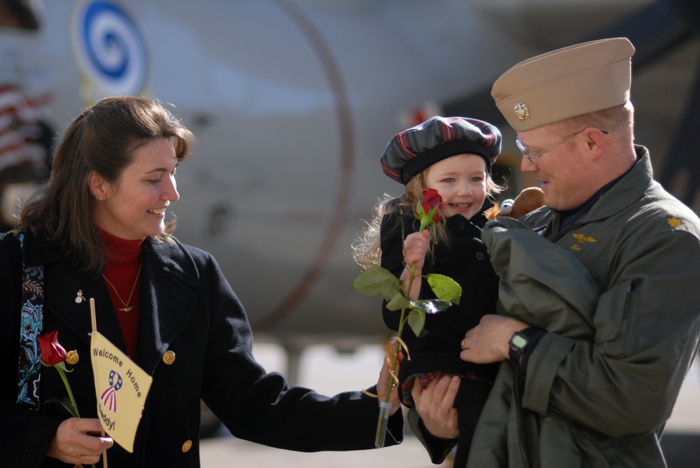 Naval Flight Officer Holds Daughter Upon Homecoming