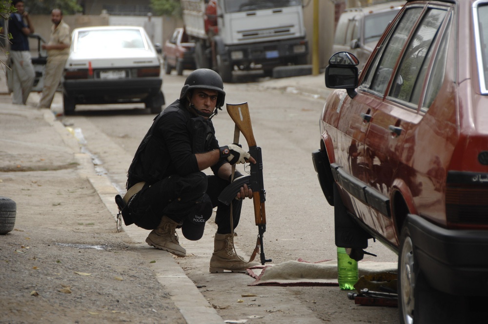Iraqi police patrol Rashid district